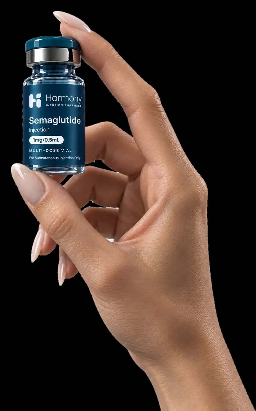 A hand holding a vial of compounded medication
